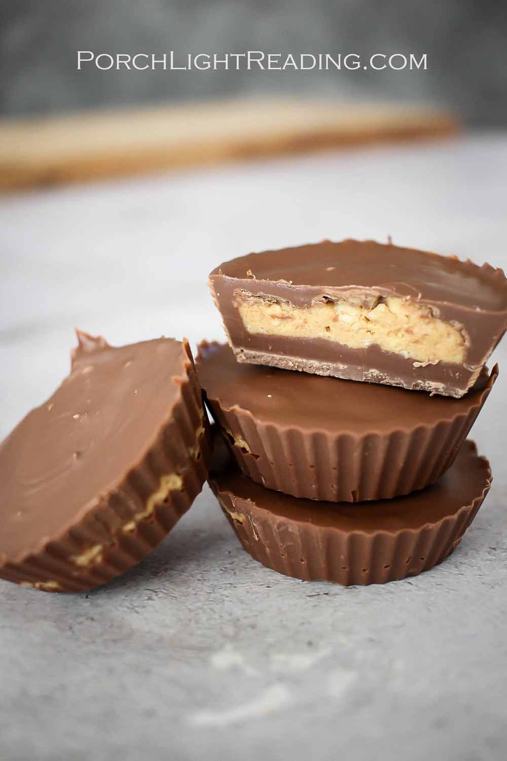 Homemade milk chocolate peanut butter cuts on a gray countertop.