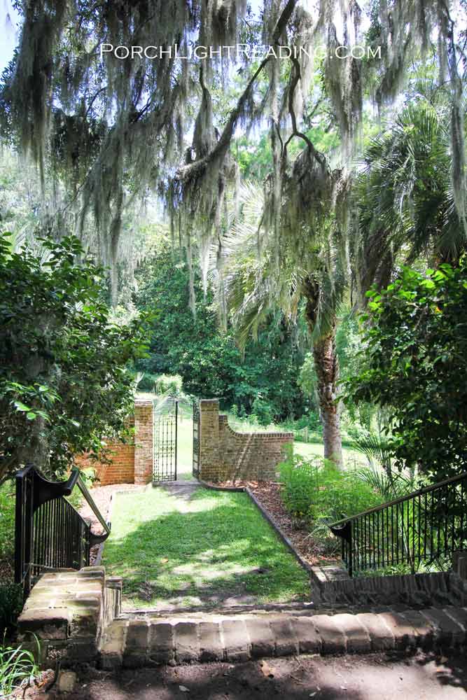 Brick stairway leading to a rod iron gate.