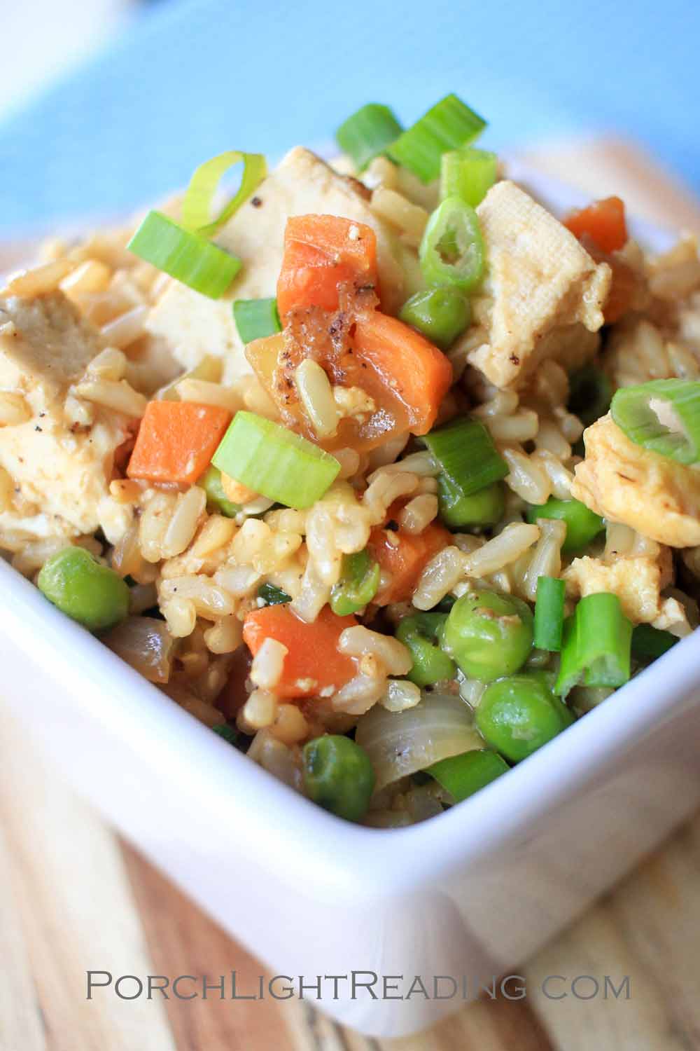 Tofu stir fry with carrots and green onions.
