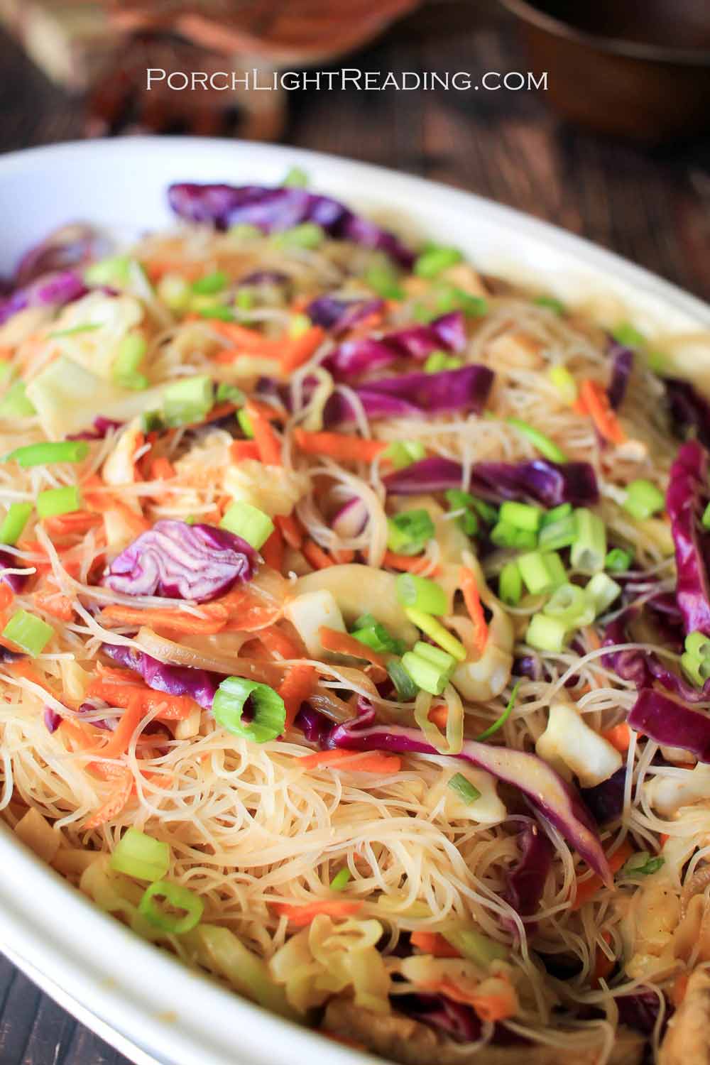 Pancit noodles with thin sliced purple cabbage and veggies.