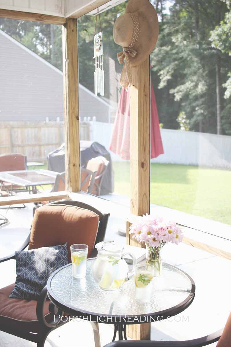 Screened in porch with added decor found around the house. Such as hats and wind-chimes. 