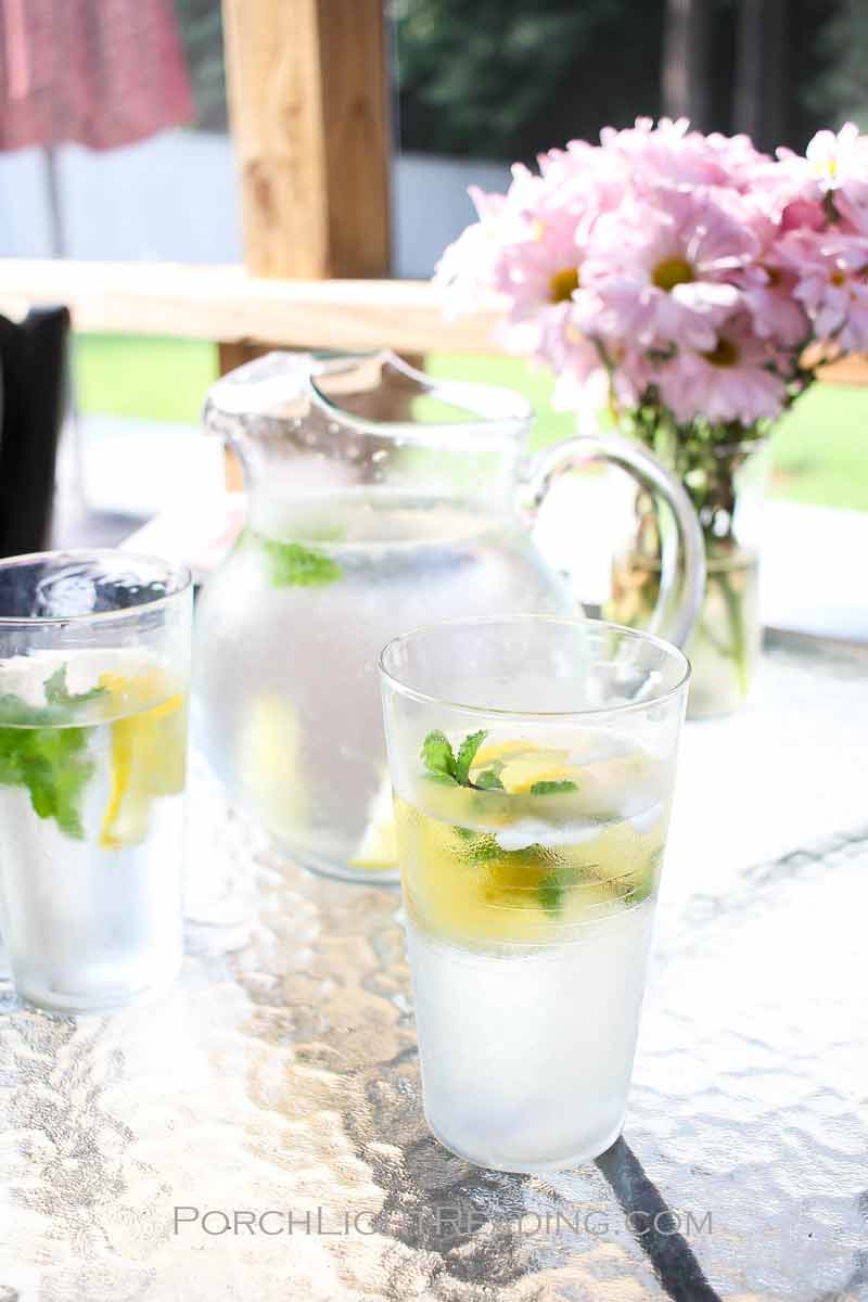 Ice cold lemonade and a pitcher of flowers in the screened in porch. 