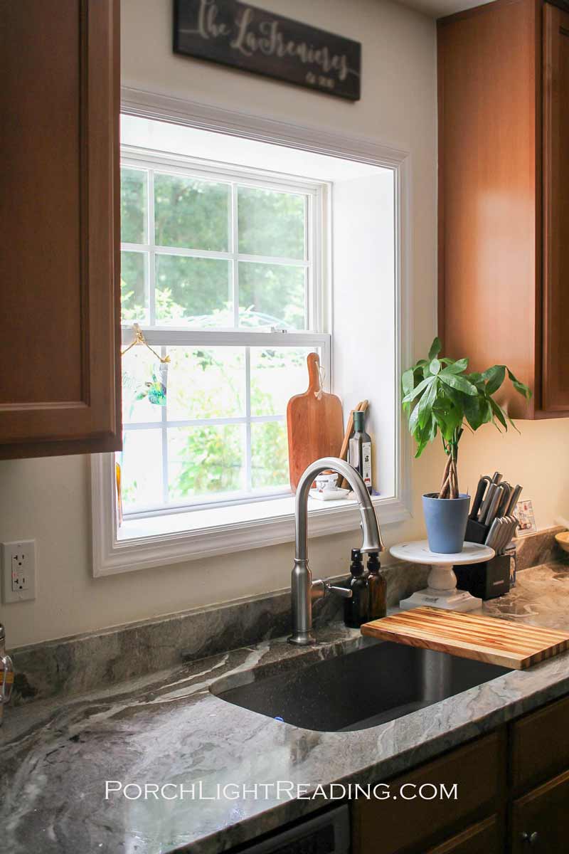 No backsplash above kitchen sink and around recessed window.