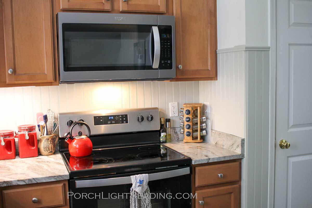 Light gray beadboard planks behind stove.