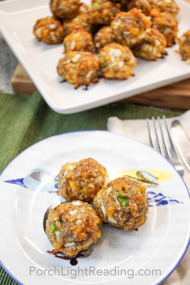 Breakfast sausage balls on a white and blue plate. 