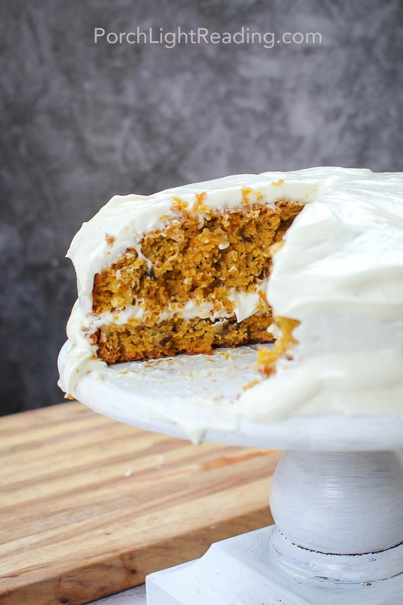Slice of carrot cake missing from cake stand.