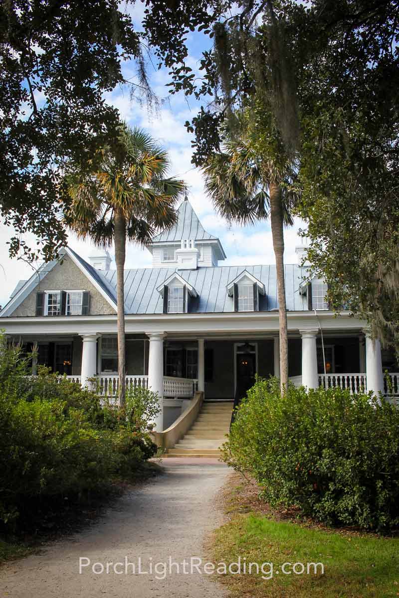 Magnolia House with Palmetto trees in front.