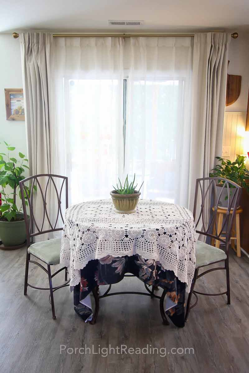 Floor to ceiling beige curtains. 