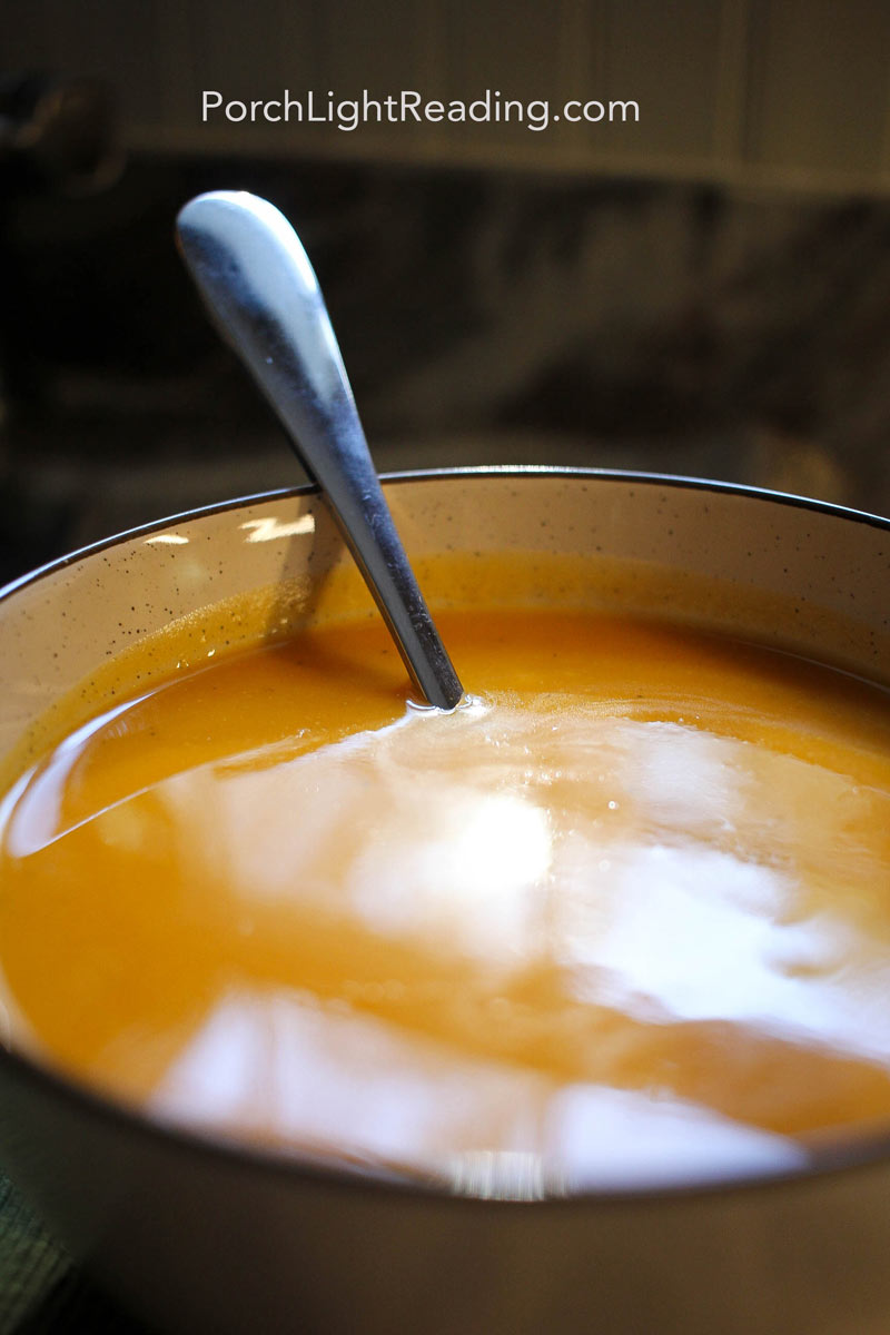 Rich and creamy butternut squash in a light tan colored serving bowl.