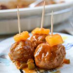 Hawaiian meatballs with a pineapple garnish.