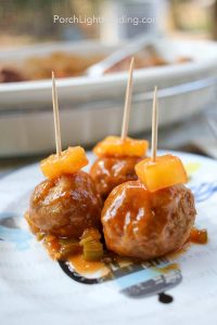 Hawaiian meatballs with a pineapple garnish.