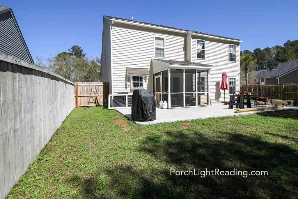 Empty backyards with concrete patio. 