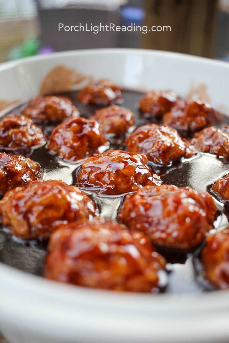 Vegetarian meatballs in a serving dish with tangy sauce. 