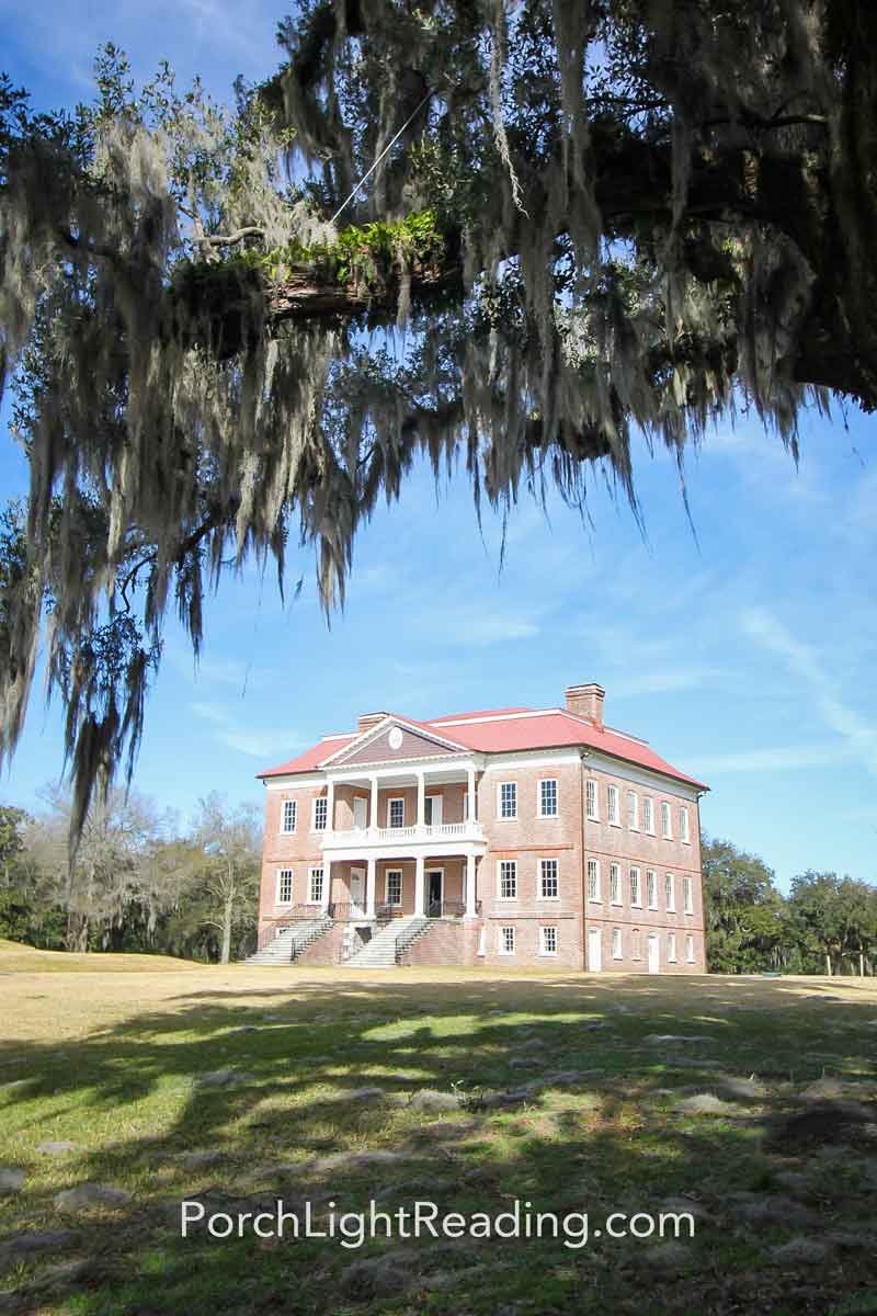 Drayton Hall Plantation framed by a live oak tree coved in Spanish moss.