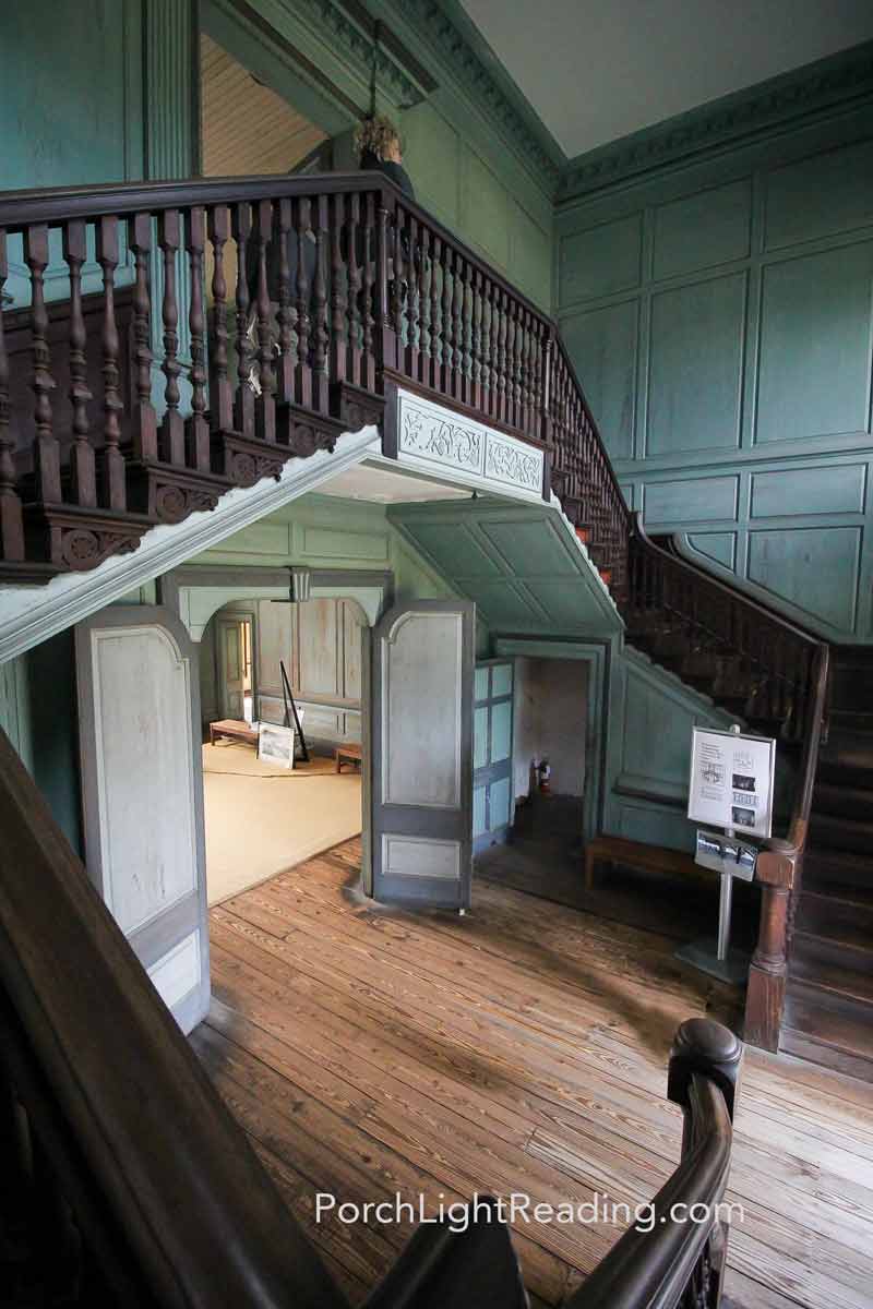 Grand staircase with ornate wood details.
