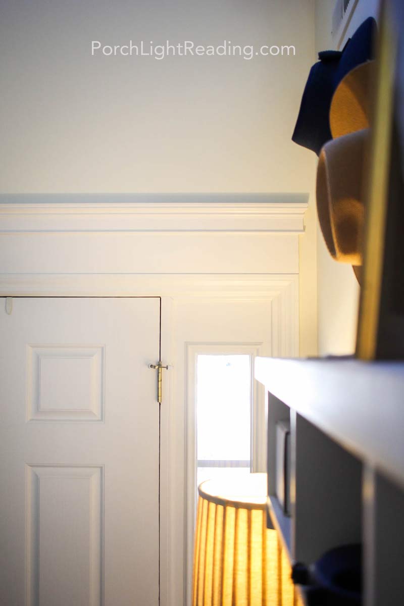 Four inch baseboard trim and three inch crown molding, framing the top of the entryway door. 