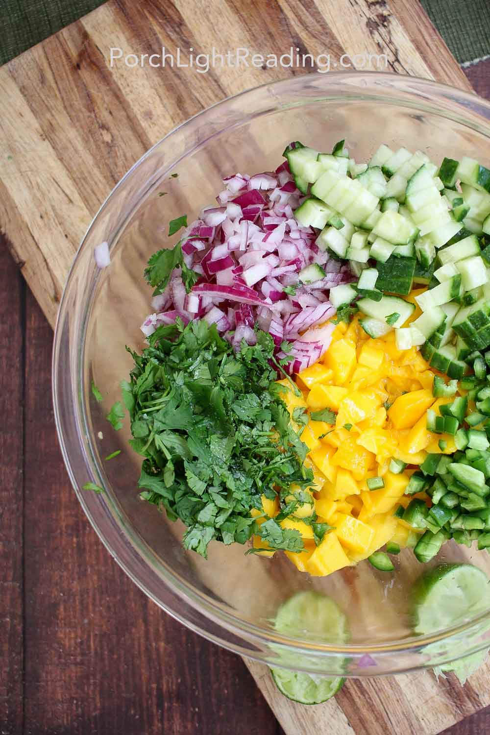 Mango salsa ingredients diced in a glass bowl.