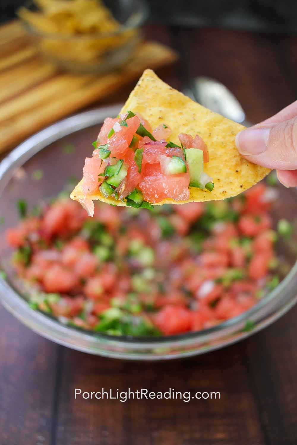 Vibrent watermelon salsa on a salty tortilla chip.