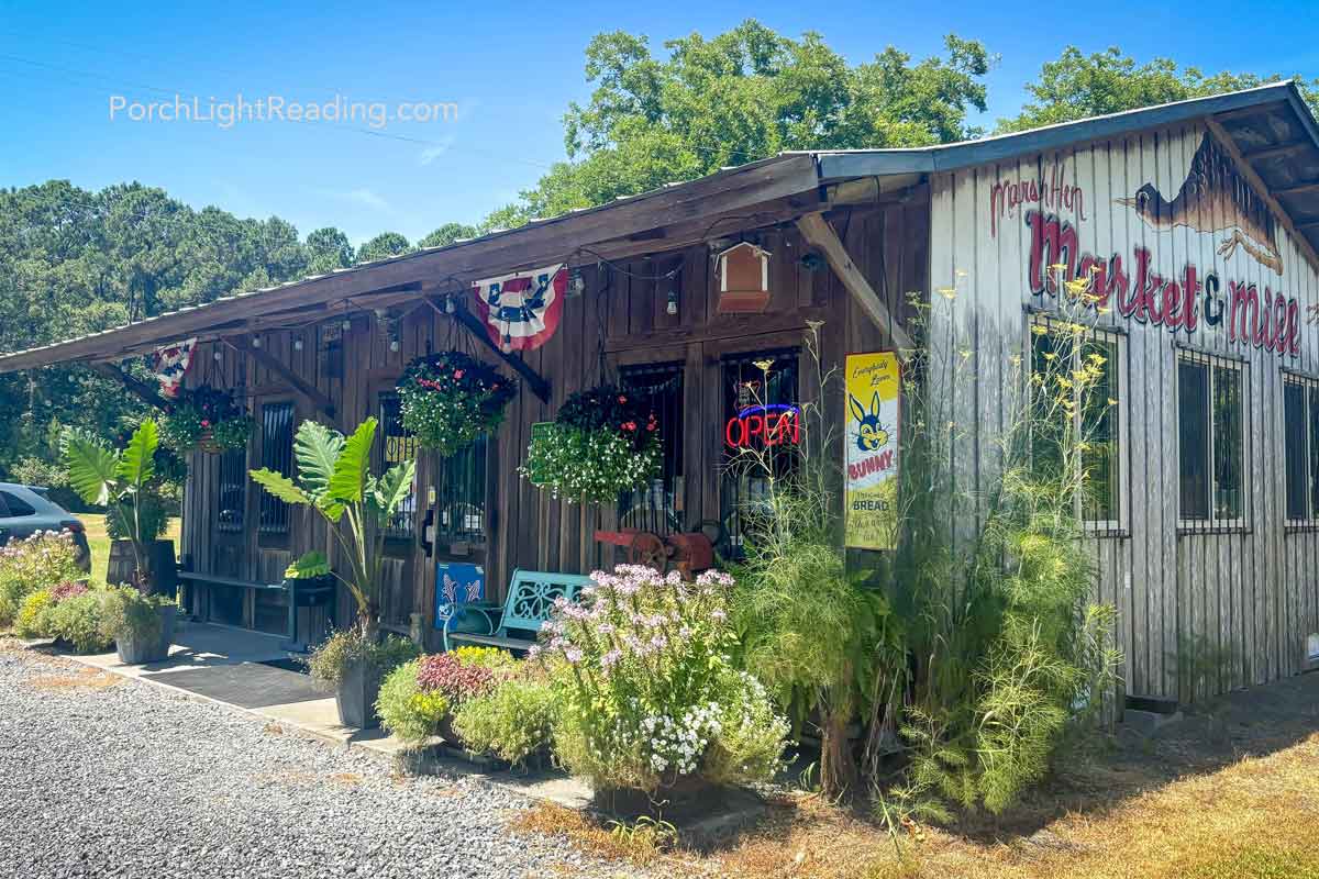 Rustic farm stand with hanging plants. 
