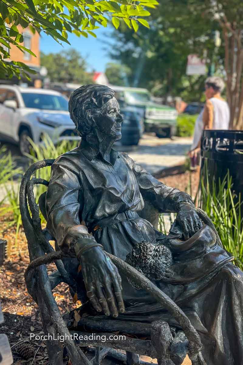 Beautiful iron sculpture of an older woman sitting in a rocking chair. 