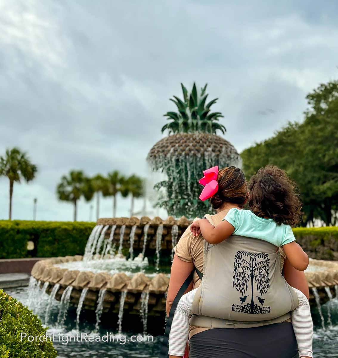 Mom and toddler enjoying Pineapple fountain downtown Charleston. 