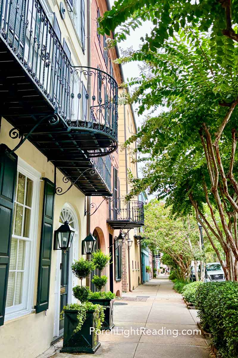 Balconies and trees lining Rainbow Row. 