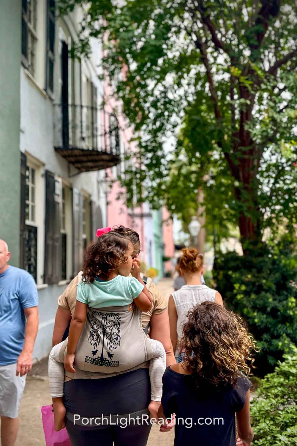 Mom and family walking up the street to Rainbow Row in downtown Charleston, SC. 