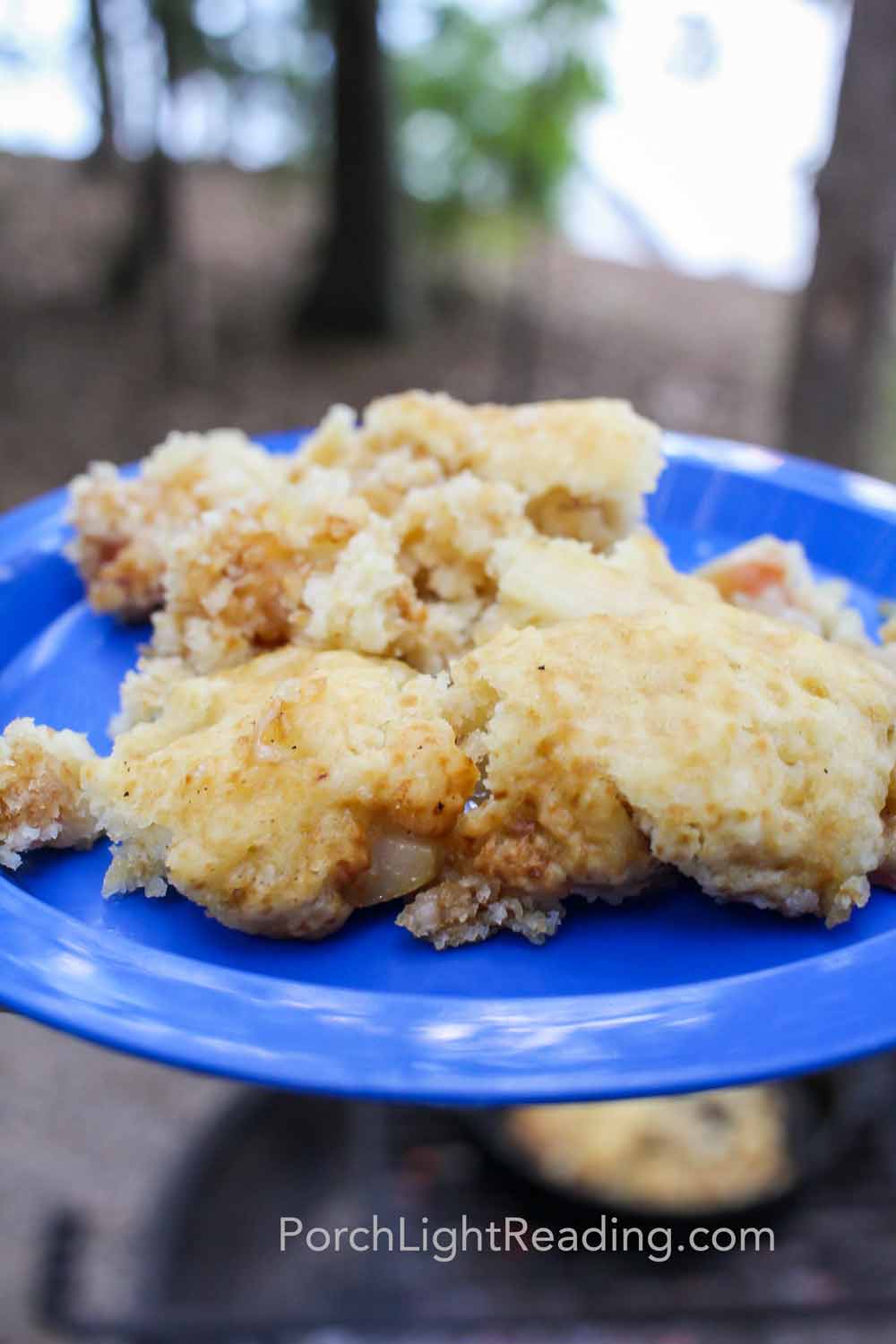 Warm apple cobbler on a blue plate. 