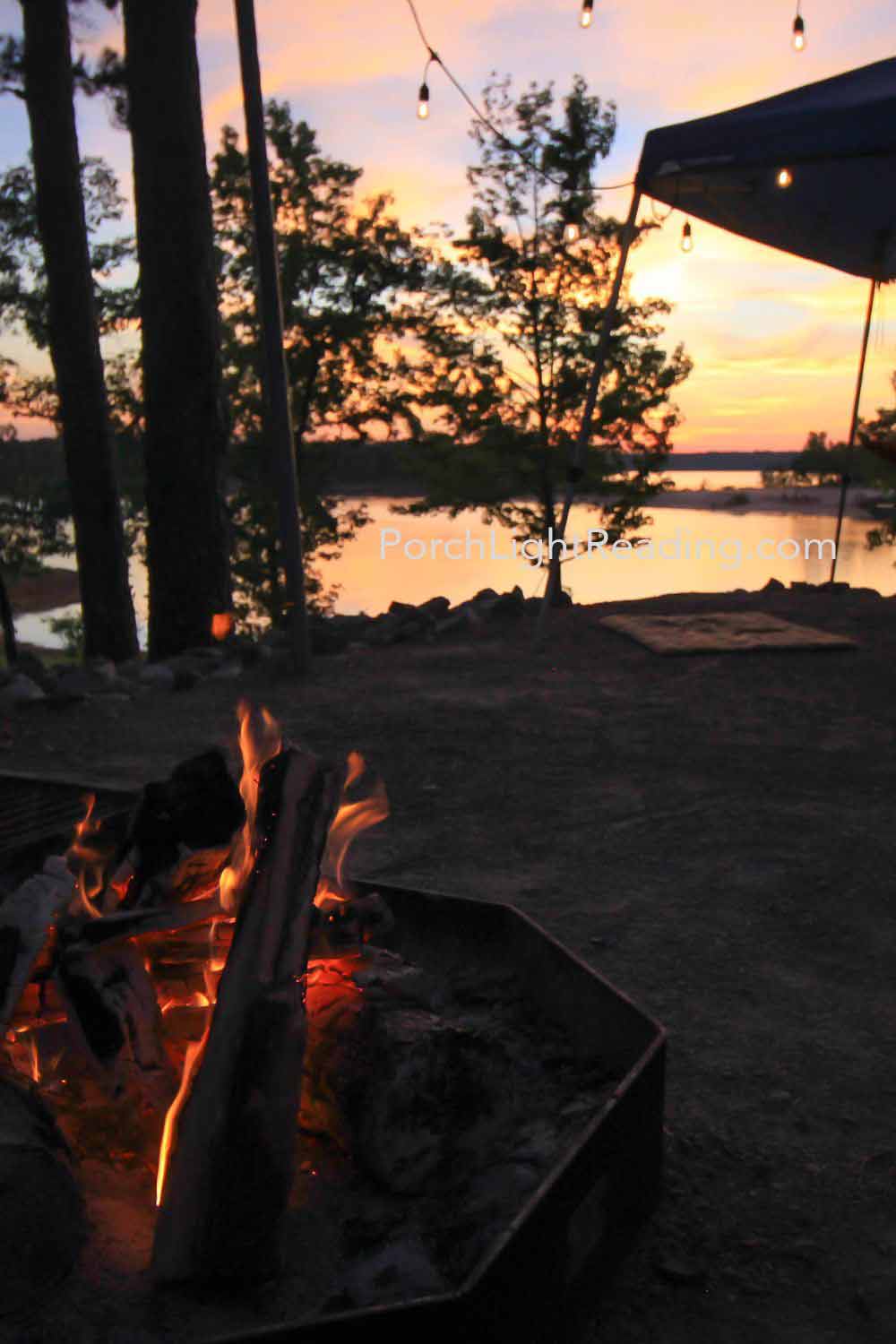 Glowing embers in the firepit as the sun sets over the lake. 
