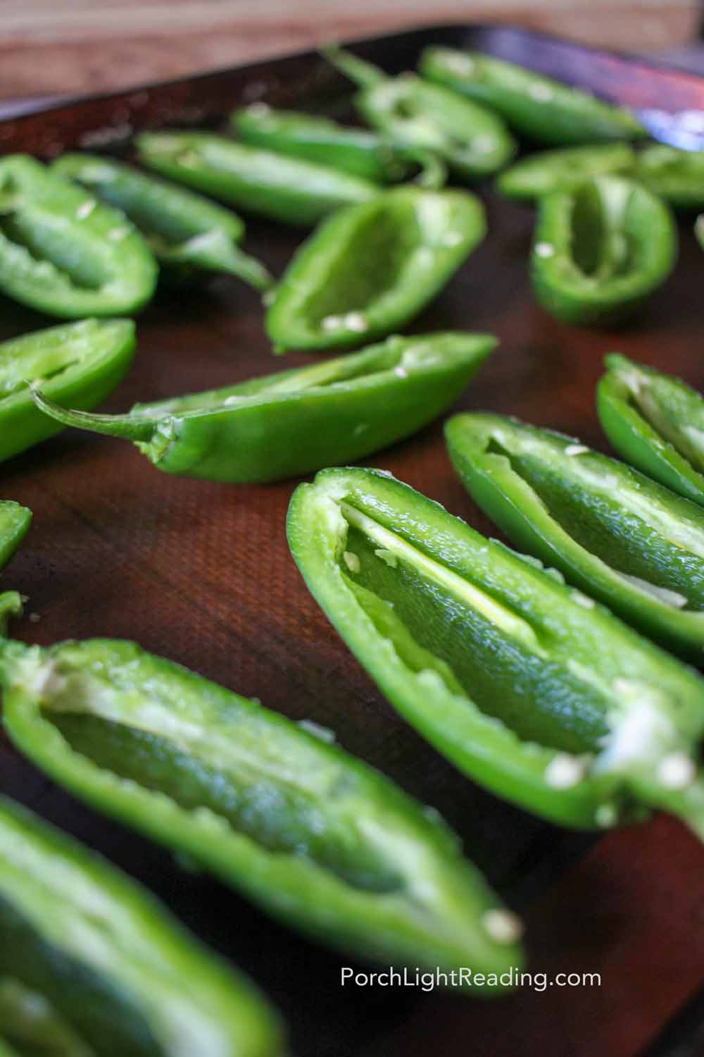 Deseeded jalapeños on a baking sheet. 