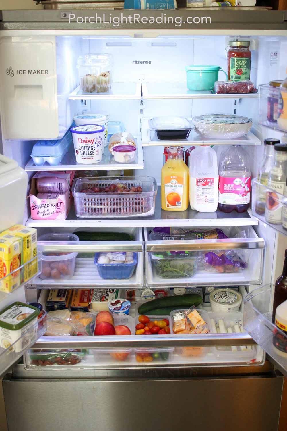 Organized refrigerator for easy grab and go snacking with cheese, grapes, carrots and more. 