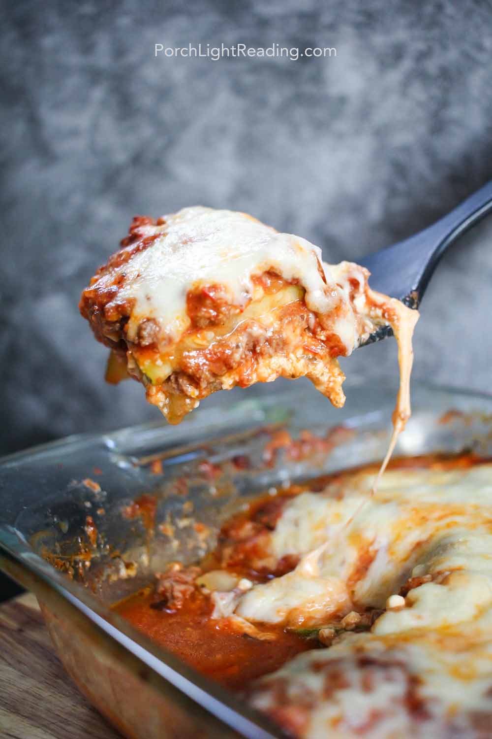 Zucchini lasagna on a spatula for serving.