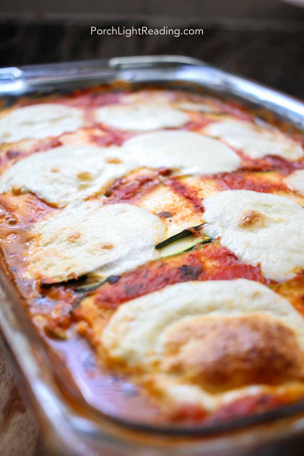 Baked zucchini lasagna in a glass dish.