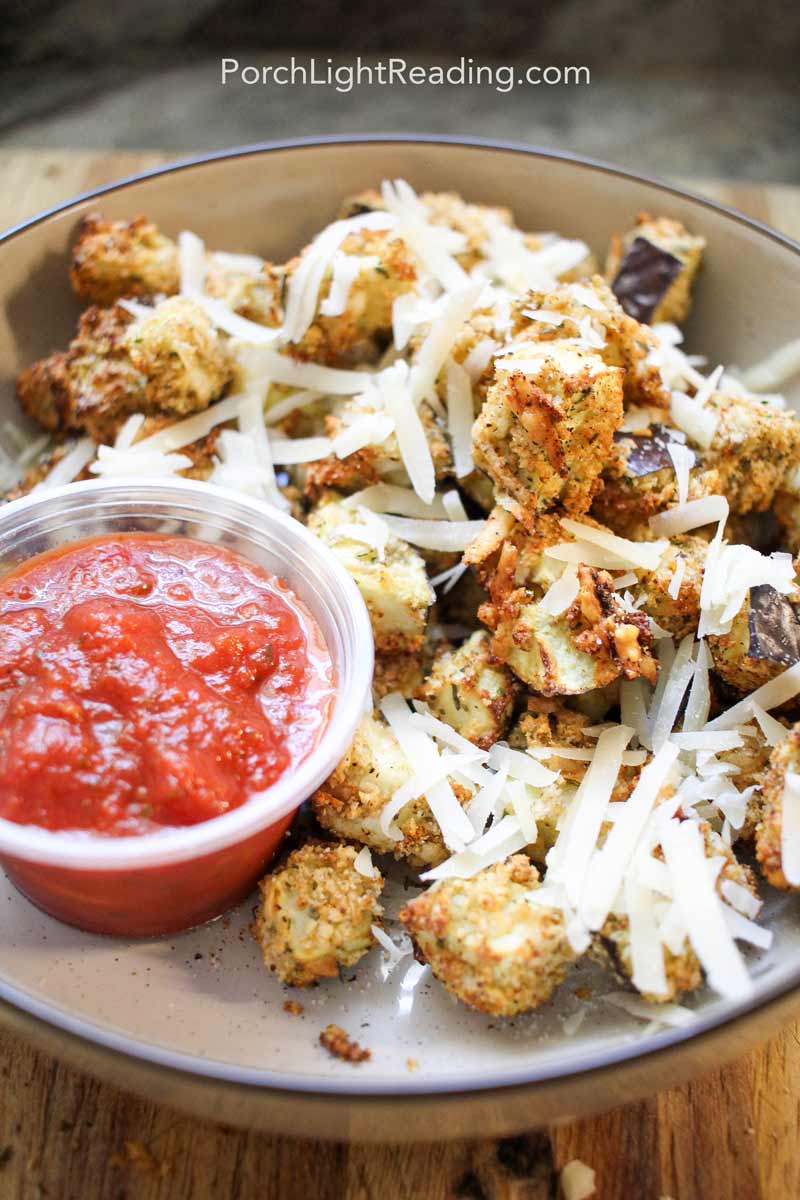 Air fryer eggplant bites topped with Parmesan cheese. 
