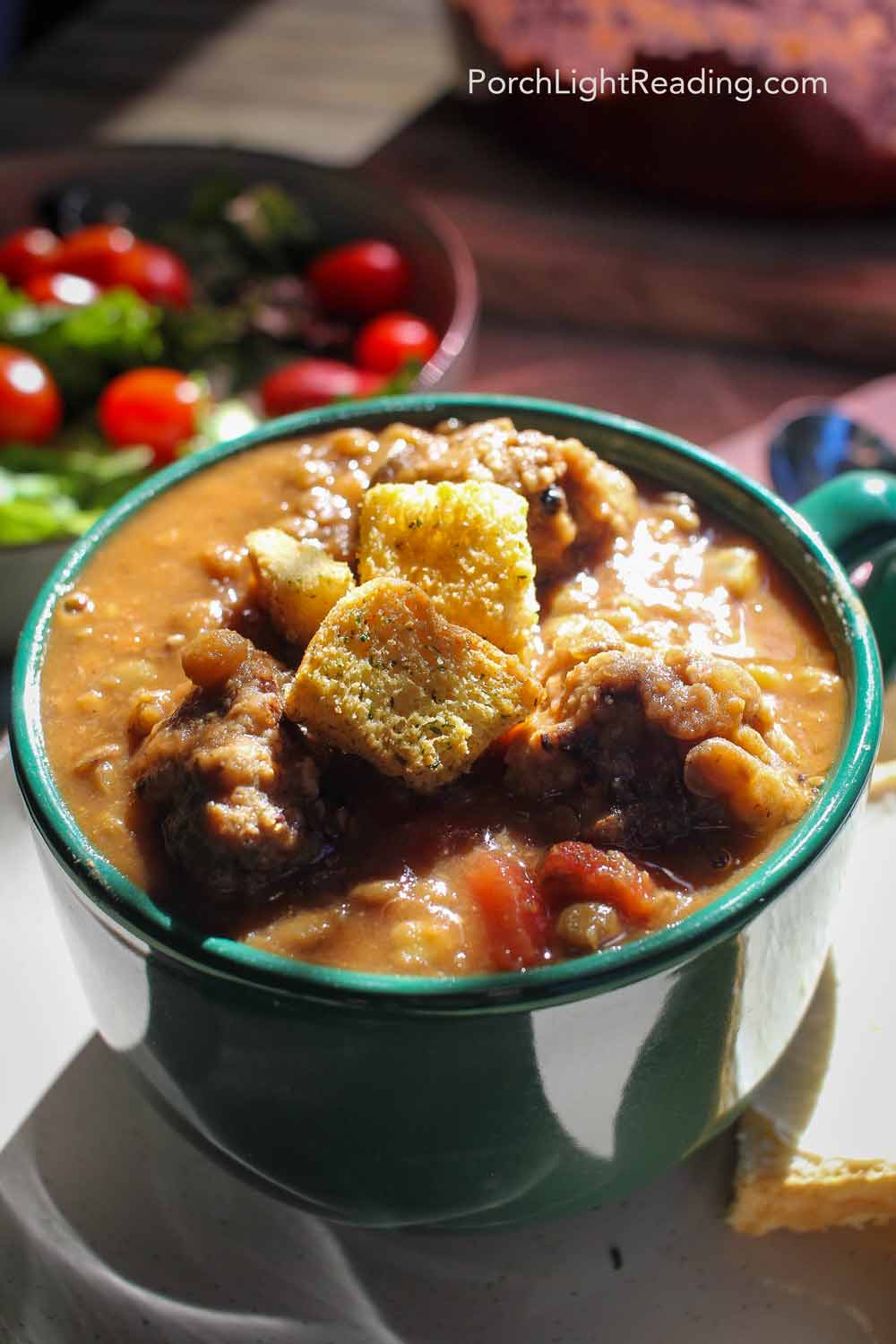 Family dinner with warm lentil soup topped with croutons. 
