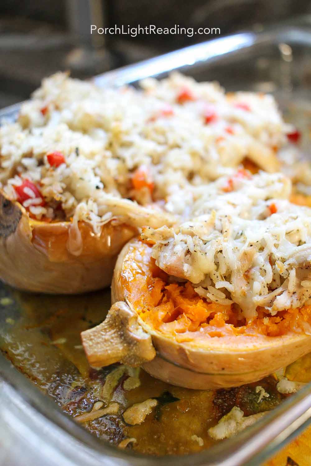 Chicken and rice stuffed butternut squash topped with cheese.