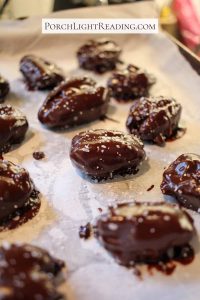 Chocolate covered dates on parchment paper.