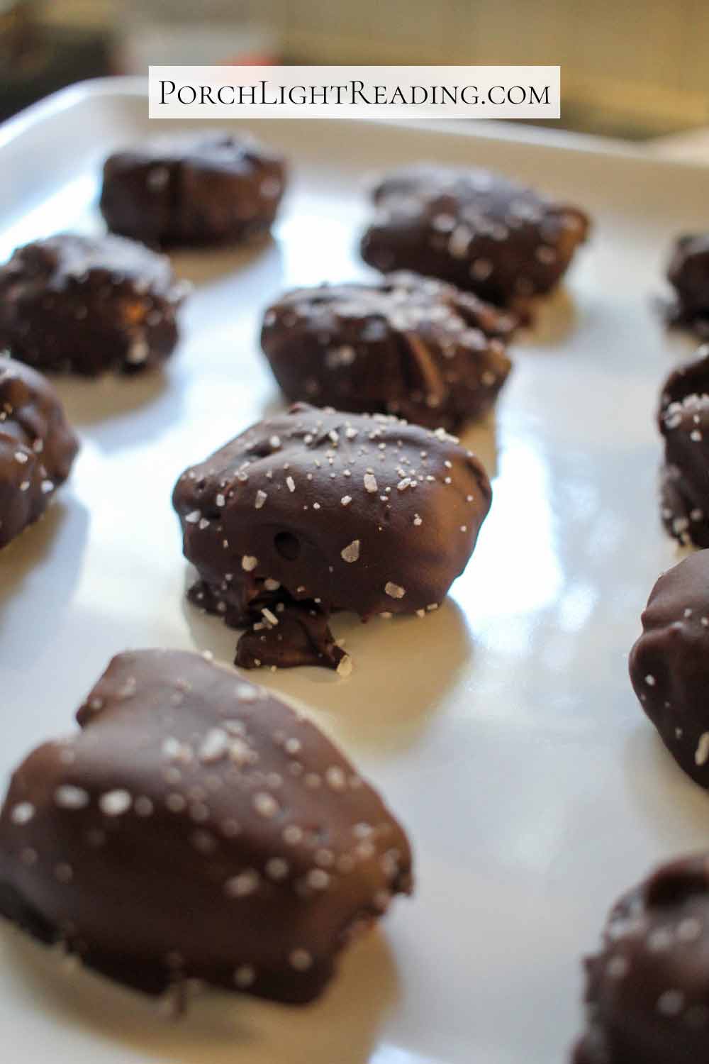 Plate of date snickers bars with course sea salt sprinkled on top.