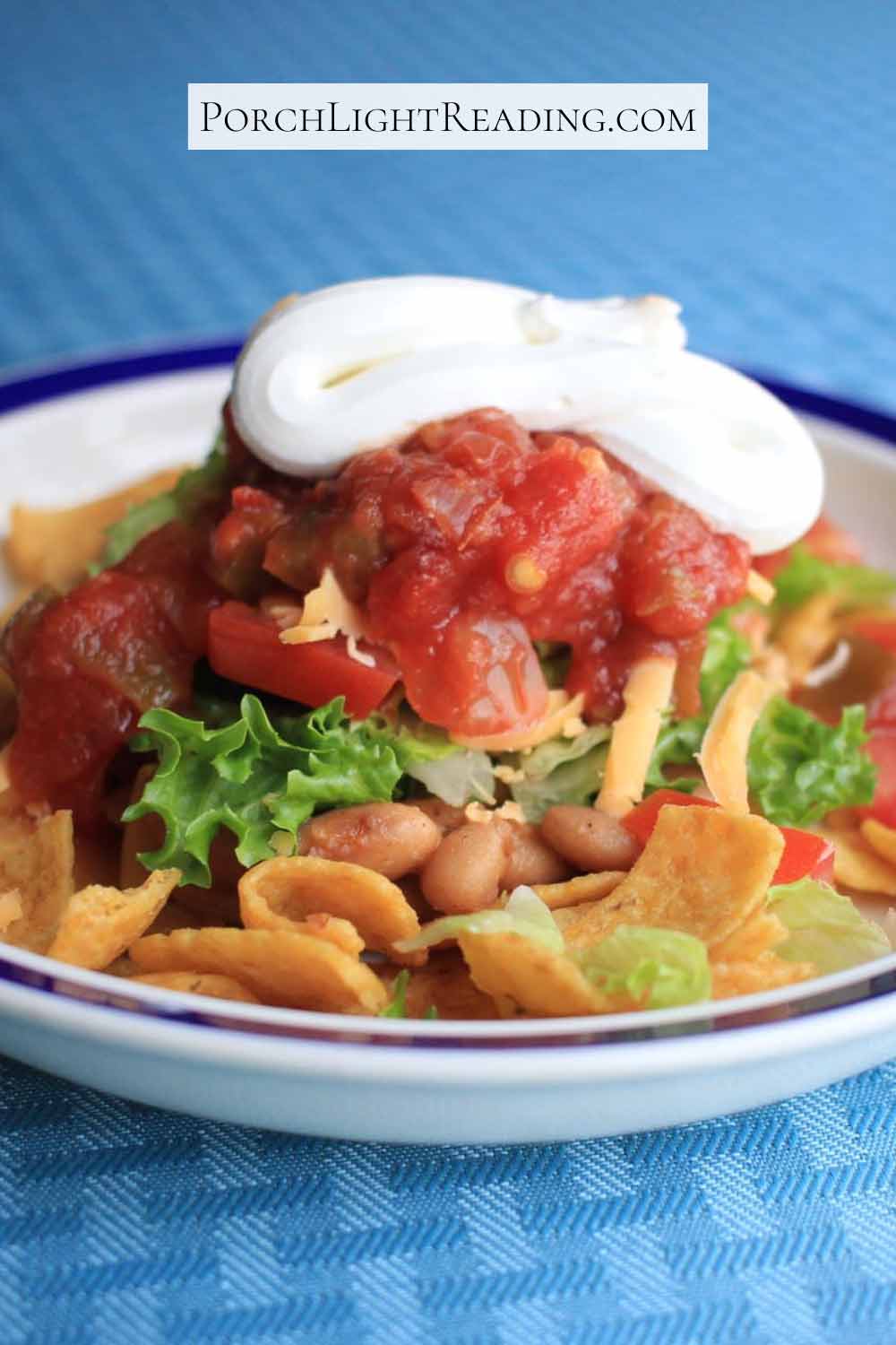 Haystack taco salad topped with sour cream. 