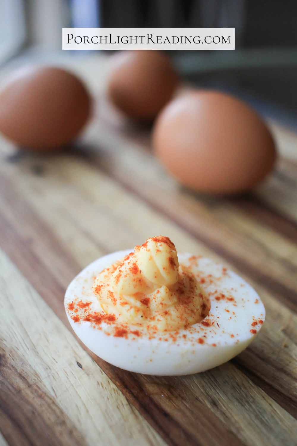 Deviled egg topped with paprika. 