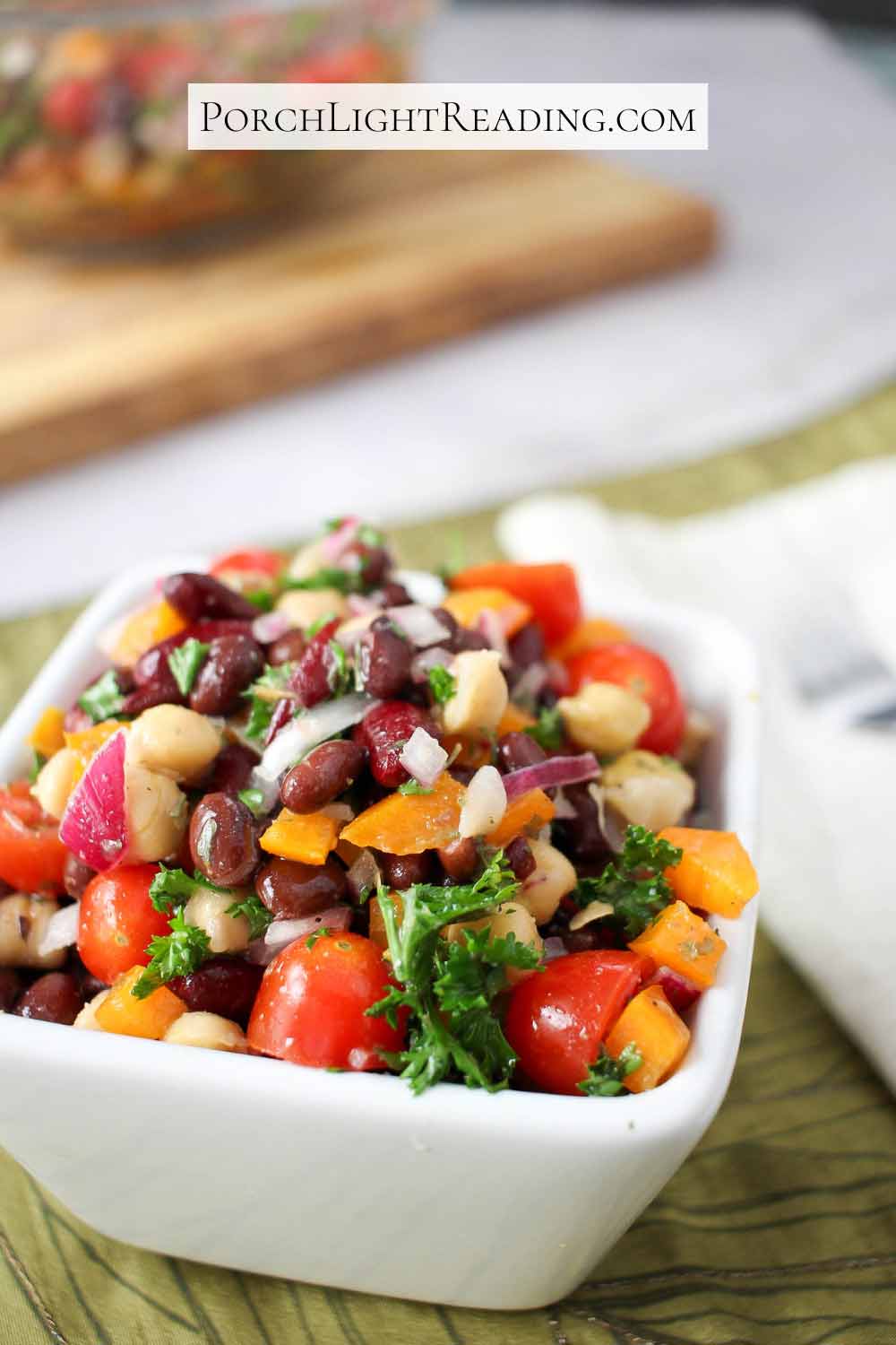 Brightly colored three bean salad with fresh parsley. 