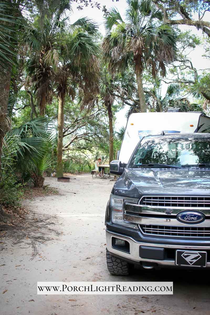 Gray truck backed into the campsite. 
