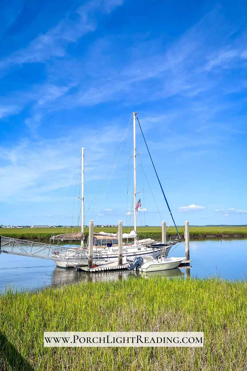 Sailboat along the marsh. 