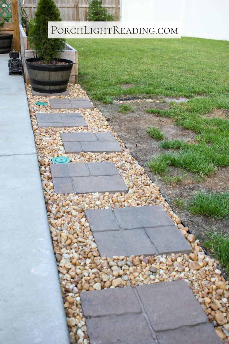 Extended patio with pavers, rocks, and edging. 