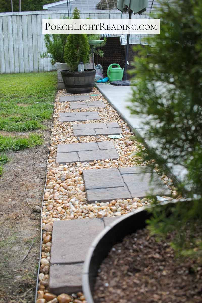 Concrete pavers off a patio surrounded by rocks. 
