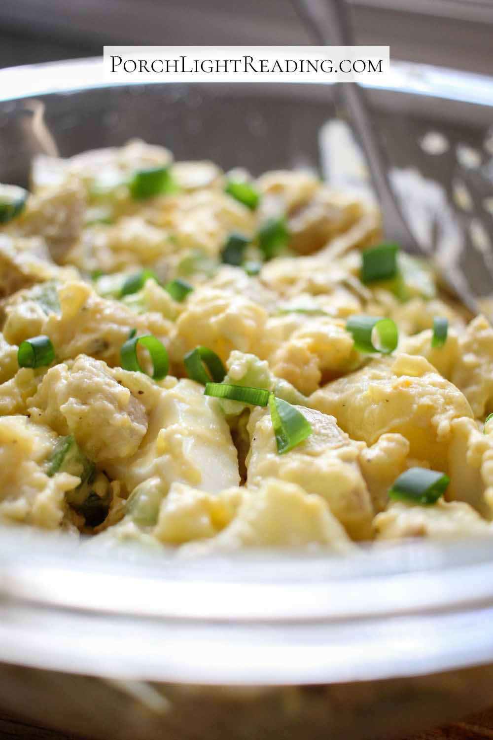 Creamy potato salad with eggs and green onions. 