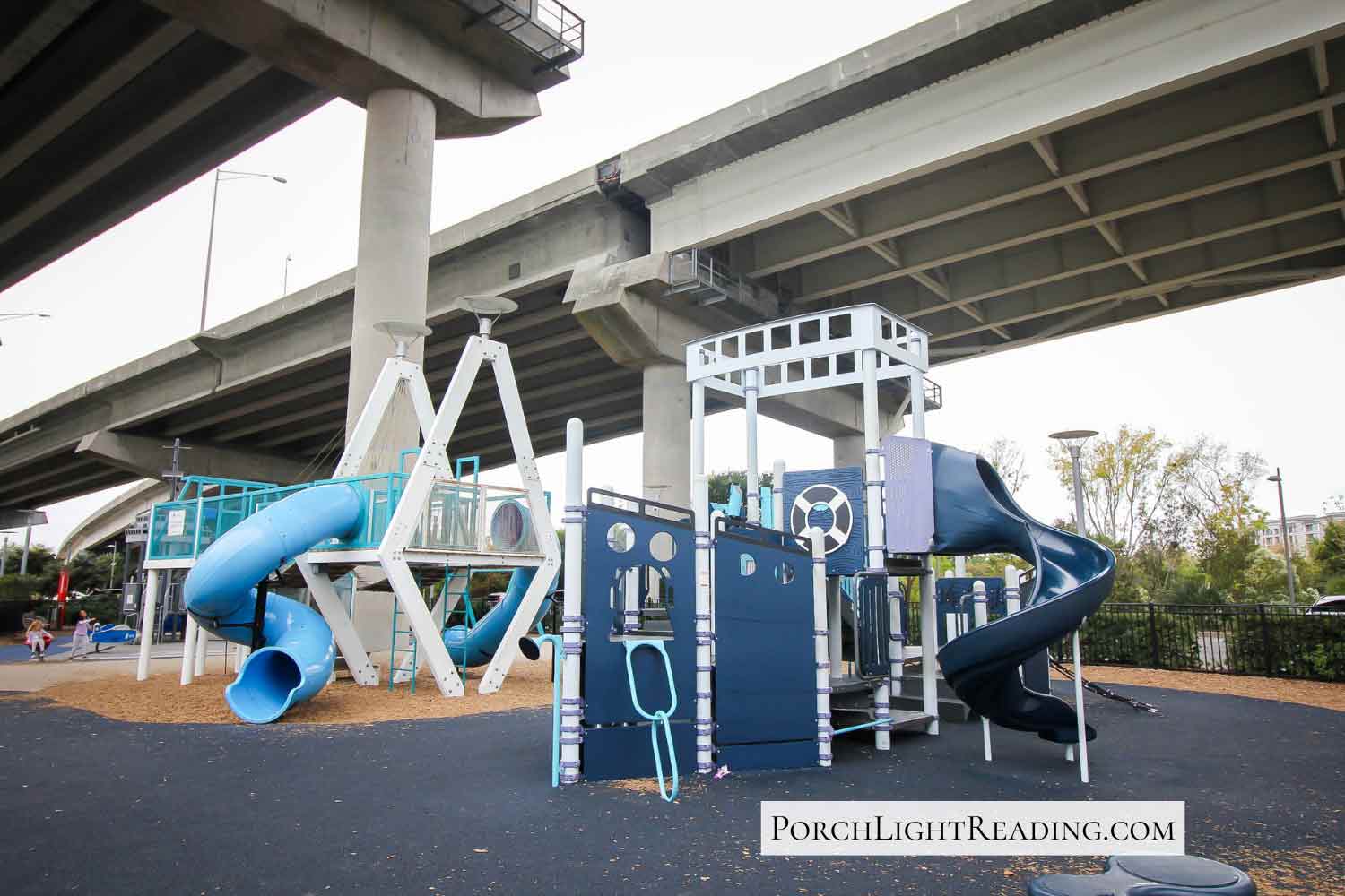 Playground under the bridge of a highway. 
