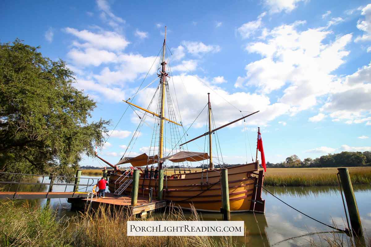 Antique looking ship with tall sails. 