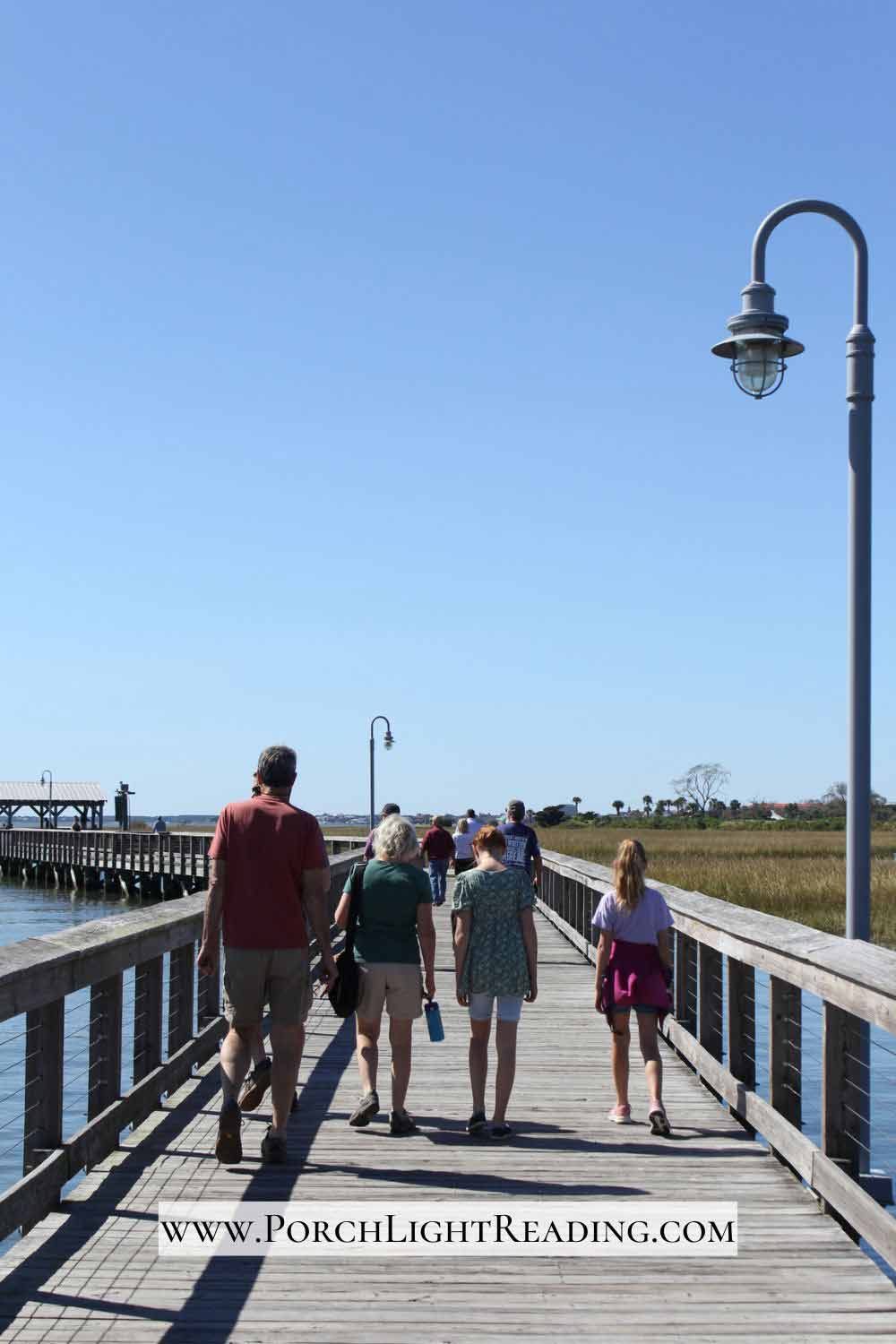 Family walking along Shem Creek Boardwalk. 