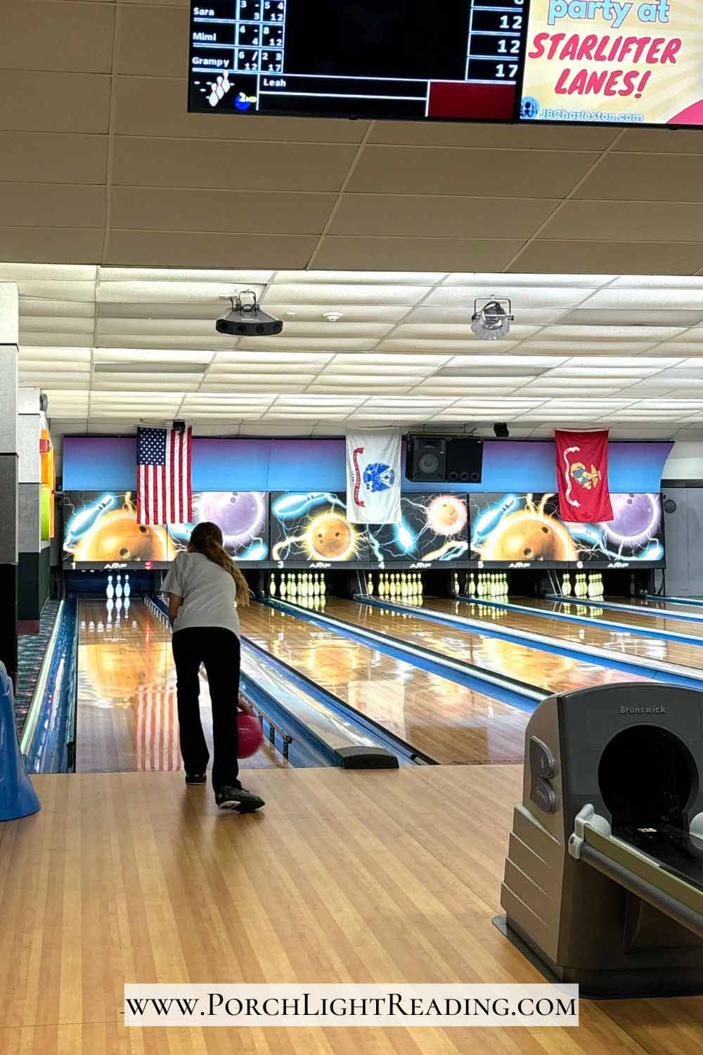 Little girl bowling at Starlifter Lanes. 